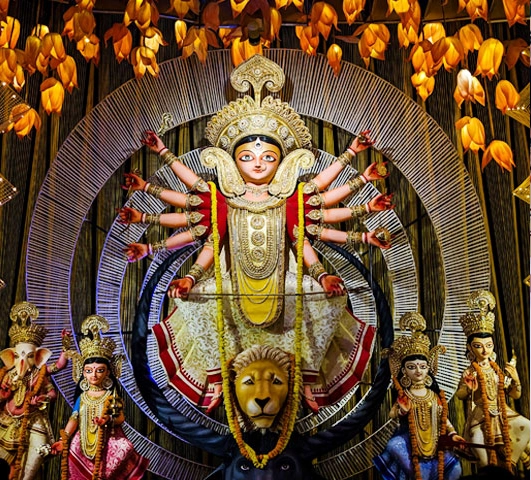 Durga Puja idol with devotees